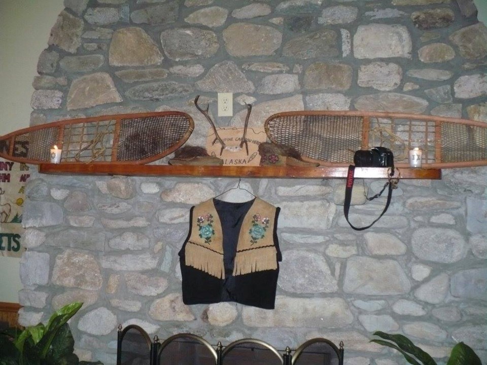 Stone wall with snowshoes mounted on it