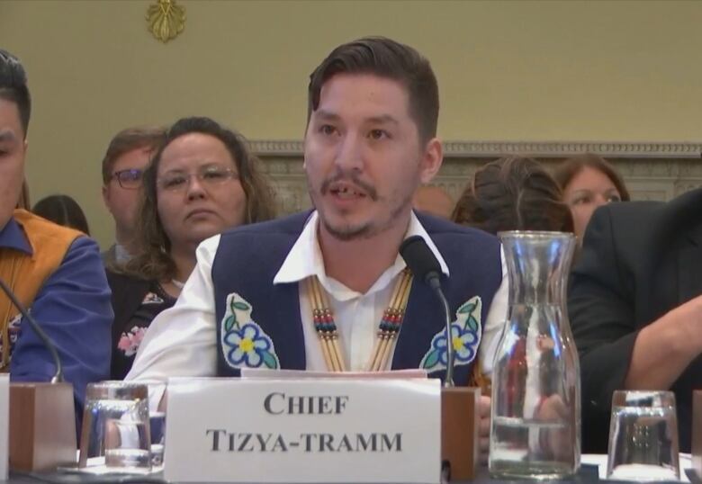 Chief Tizya-Tramm speaking at a table